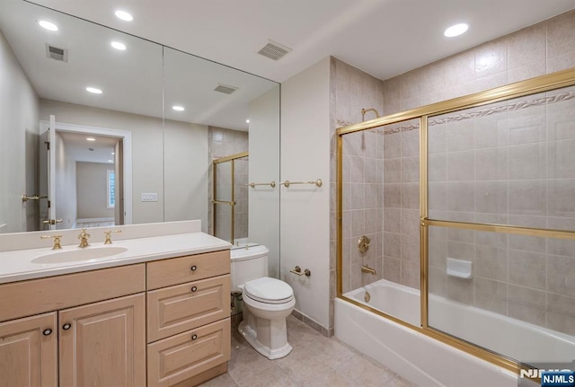 full bath featuring toilet, vanity, visible vents, combined bath / shower with glass door, and tile patterned floors