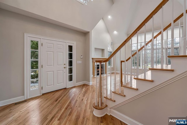 foyer entrance featuring stairway, recessed lighting, wood finished floors, and baseboards