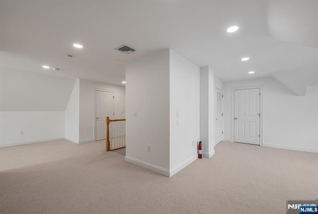 bonus room with light carpet, visible vents, and recessed lighting