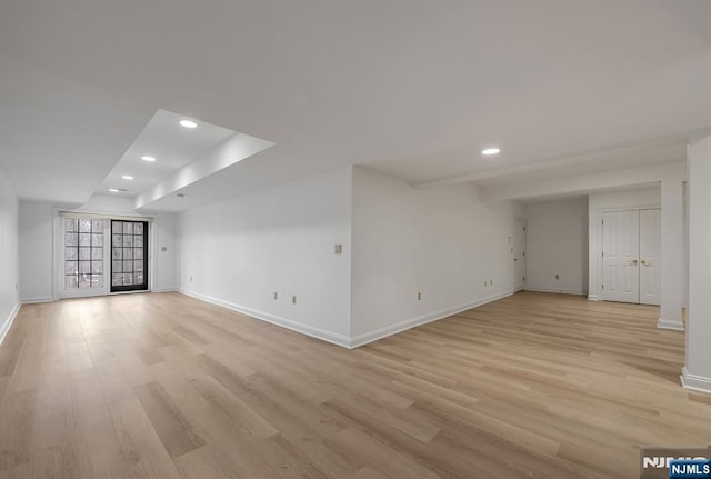 unfurnished living room featuring baseboards, light wood finished floors, and recessed lighting