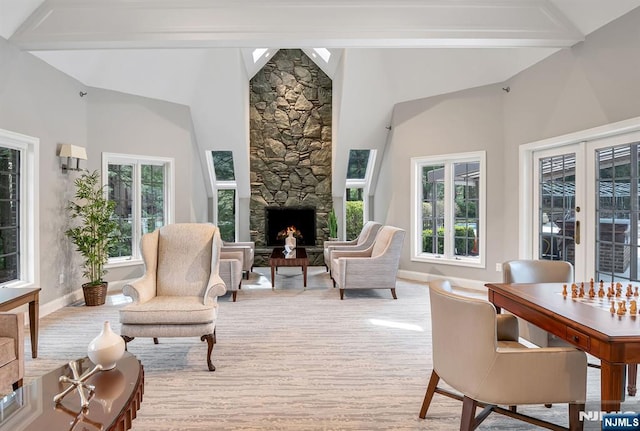 interior space featuring plenty of natural light, wood finished floors, and a stone fireplace