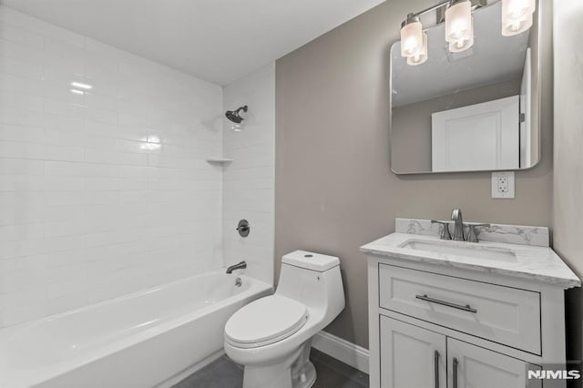 full bathroom featuring vanity, tiled shower / bath combo, and toilet