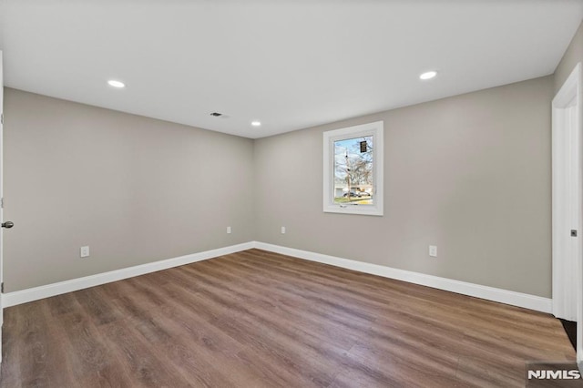 unfurnished room featuring wood-type flooring