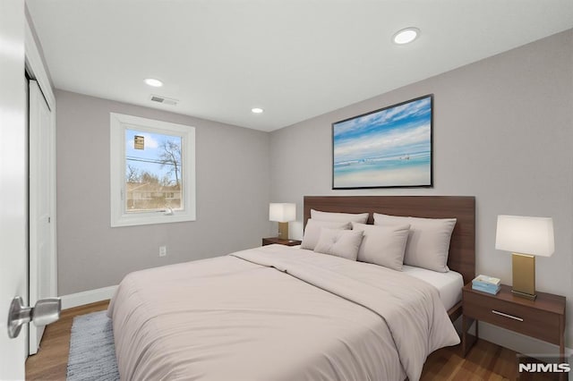 bedroom with hardwood / wood-style floors and a closet