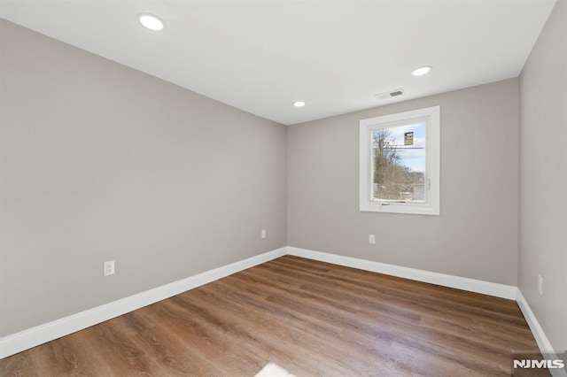 spare room featuring hardwood / wood-style floors