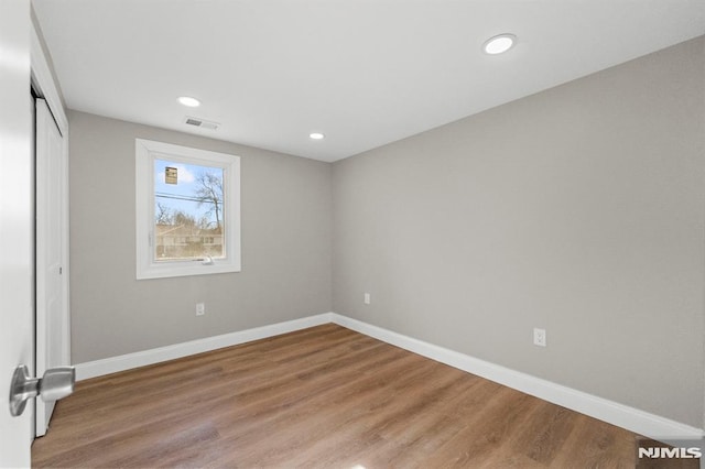 unfurnished room with wood-type flooring