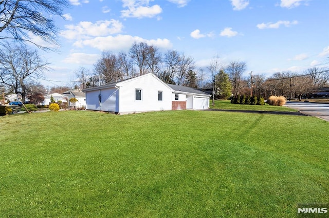 view of side of home featuring a yard