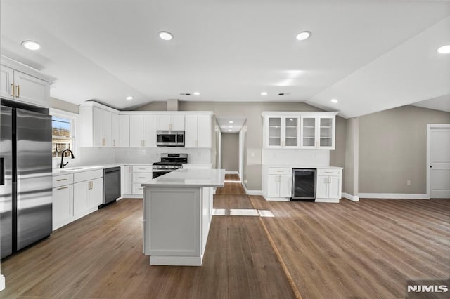 kitchen featuring white cabinets, stainless steel appliances, and wine cooler