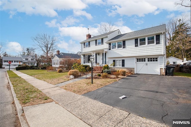 view of front of property with a front lawn and a garage