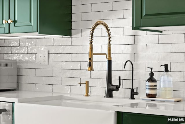 kitchen featuring green cabinets and decorative backsplash