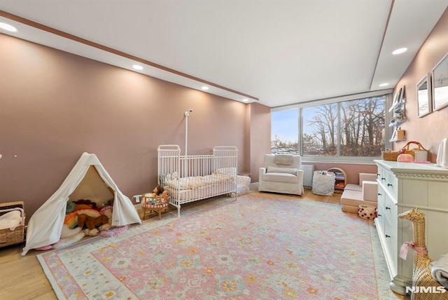 interior space with light hardwood / wood-style floors and a crib