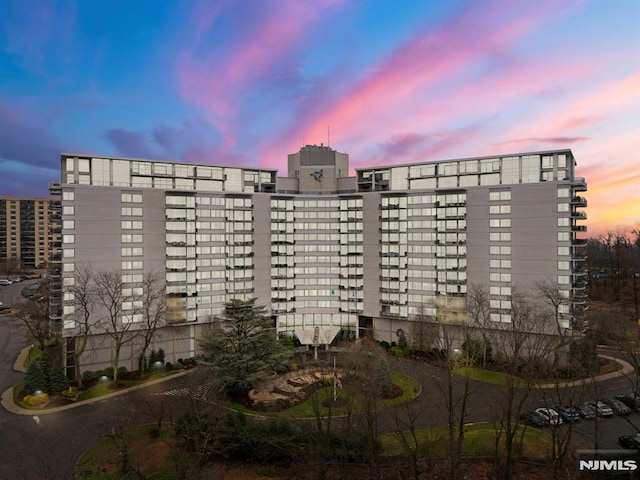 view of outdoor building at dusk