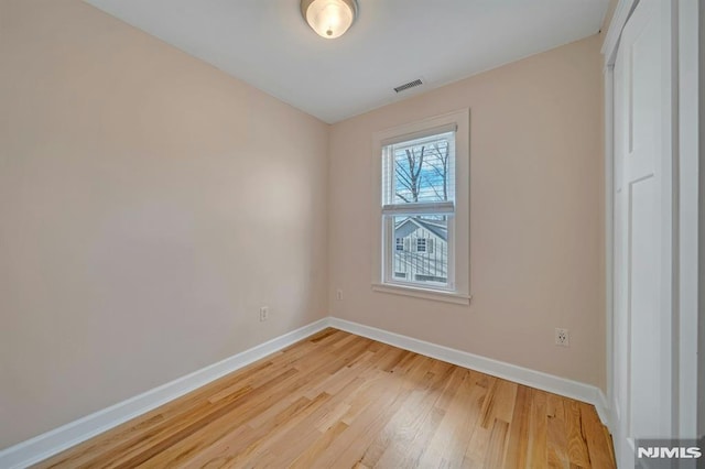 spare room featuring light wood-type flooring