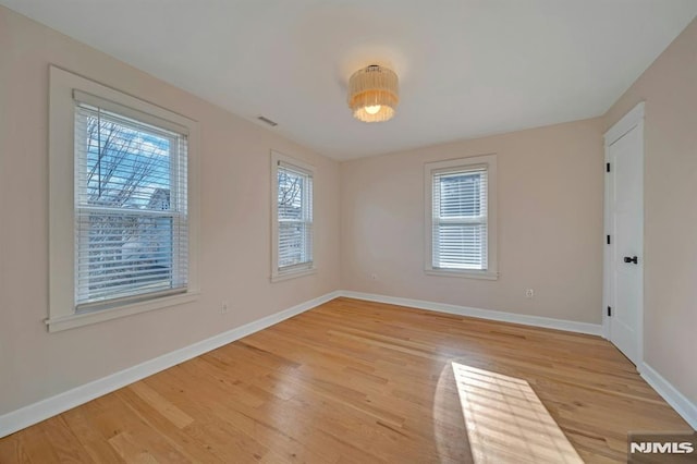 unfurnished room with light hardwood / wood-style floors