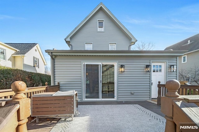 rear view of property featuring a deck