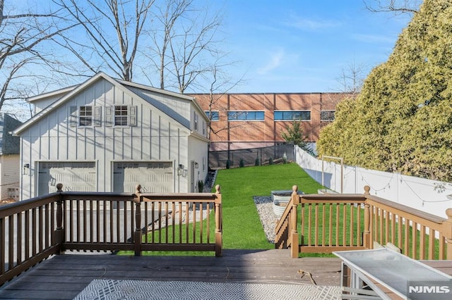 wooden deck featuring a yard and a garage