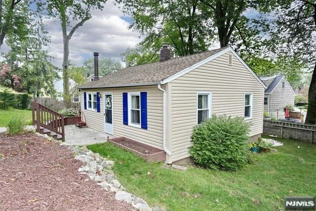 view of side of property featuring a yard