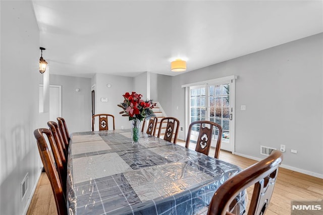 dining area with hardwood / wood-style flooring