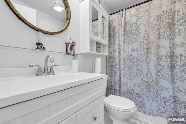 bathroom with toilet and vanity