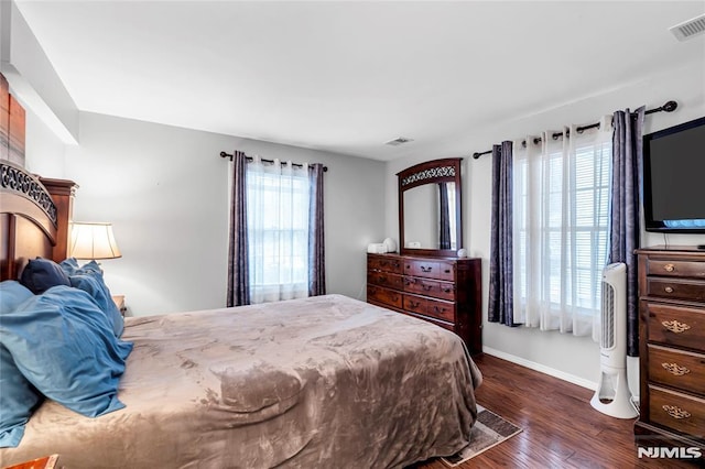 bedroom with dark wood-type flooring