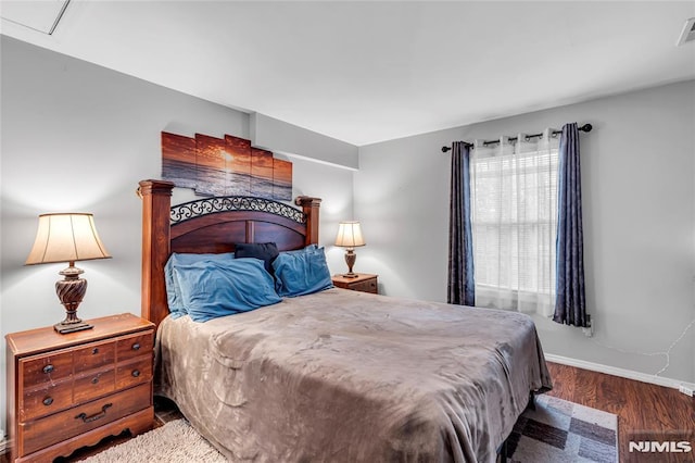 bedroom with dark wood-type flooring