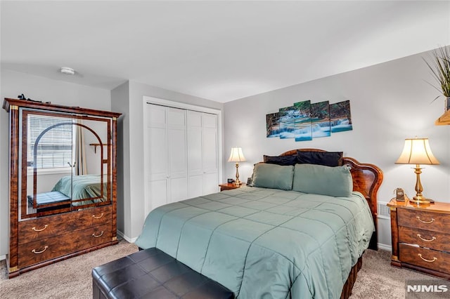 bedroom with a closet and light carpet