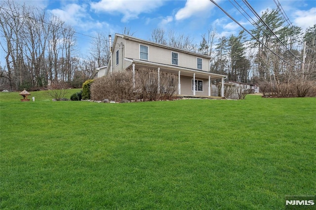 rear view of house with a lawn