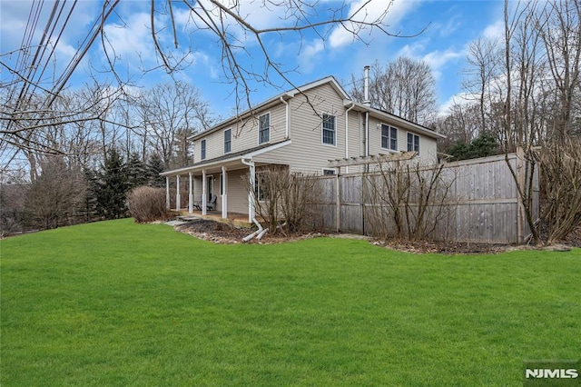 view of side of home featuring a lawn and a pergola