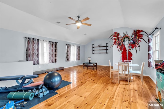 exercise area featuring hardwood / wood-style flooring, lofted ceiling, and ceiling fan