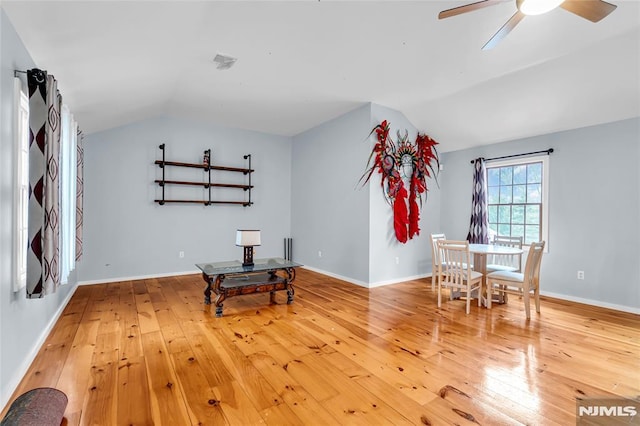 sitting room with ceiling fan, wood-type flooring, and lofted ceiling