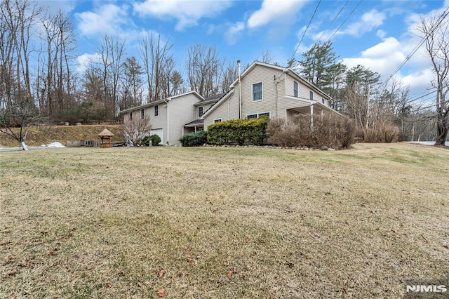 view of side of property with a yard