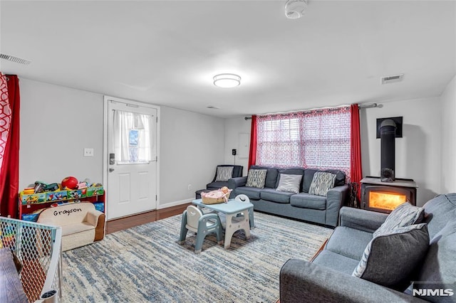 living room featuring a wood stove and hardwood / wood-style floors