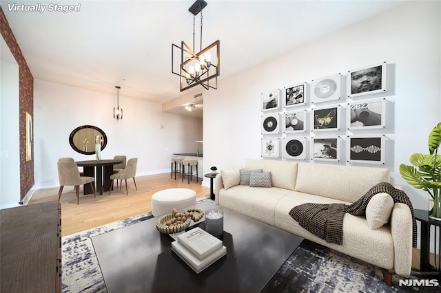 living room featuring hardwood / wood-style flooring and a notable chandelier