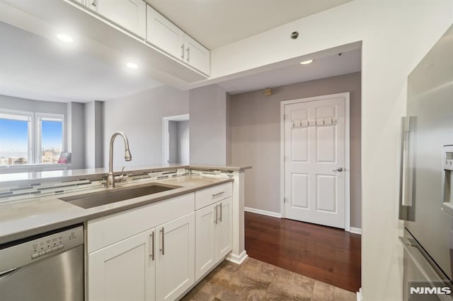 kitchen with sink, white cabinets, and stainless steel appliances