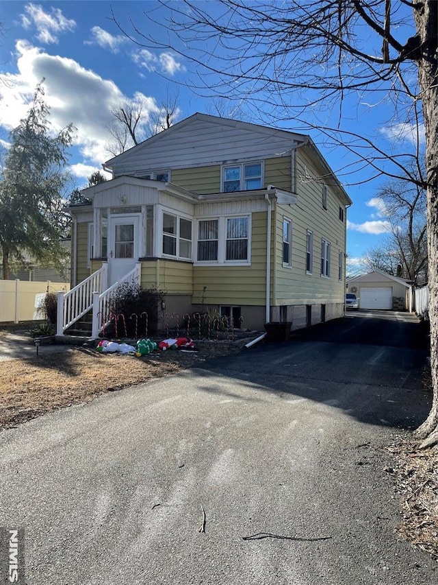 view of front of house featuring a garage and an outdoor structure