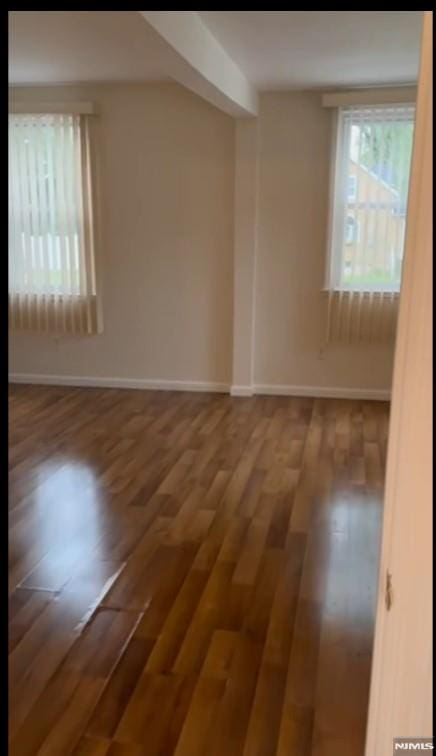 spare room featuring dark hardwood / wood-style floors