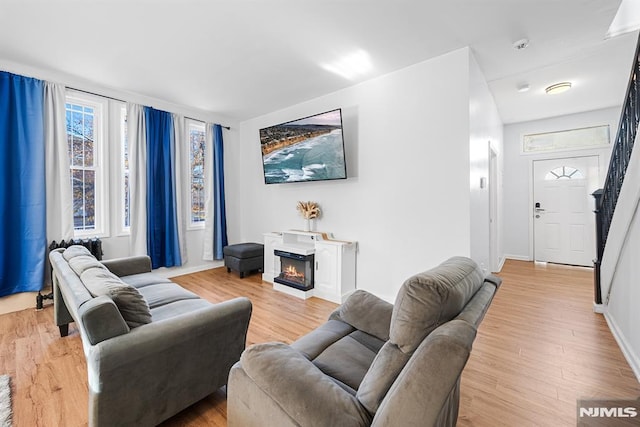 living room featuring light hardwood / wood-style flooring and a healthy amount of sunlight