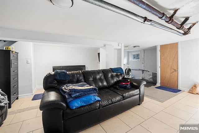 tiled living room featuring washer / clothes dryer