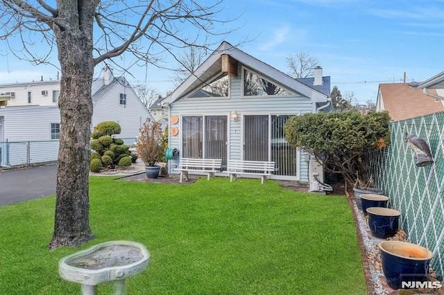 rear view of house with a lawn