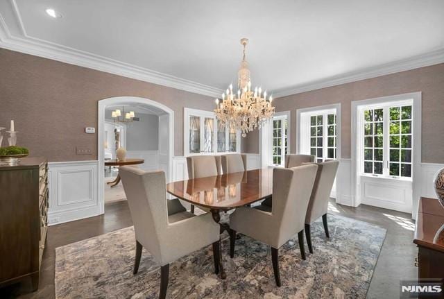 dining space with a notable chandelier and ornamental molding