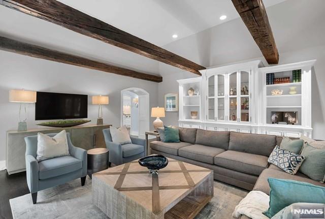 living room with beam ceiling and wood-type flooring