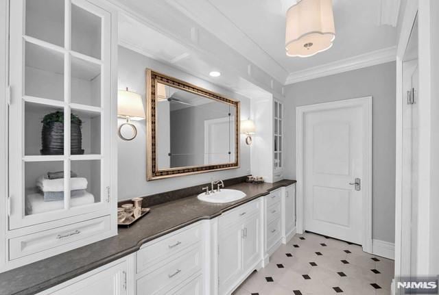 bathroom featuring vanity and ornamental molding