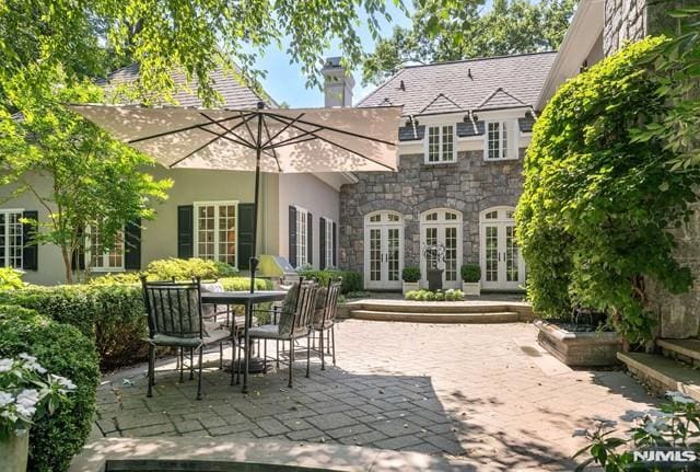 back of property with a patio area and french doors