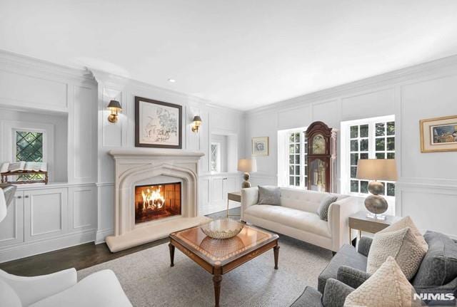 living room featuring dark hardwood / wood-style floors and crown molding