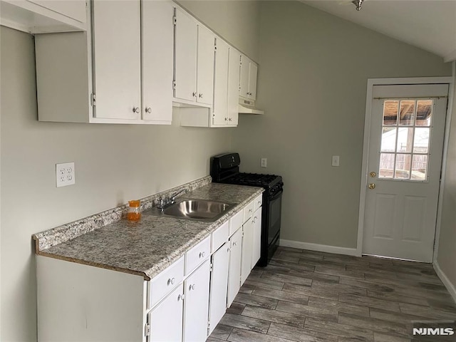 kitchen featuring white cabinets, sink, lofted ceiling, and black range with gas cooktop