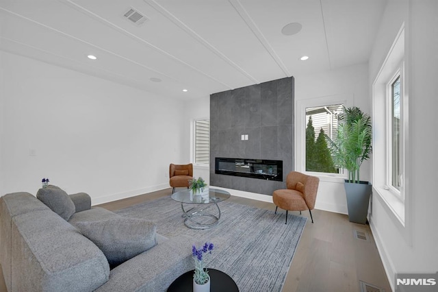 living room with a fireplace and hardwood / wood-style flooring