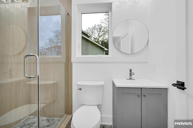 bathroom with vanity, toilet, and an enclosed shower