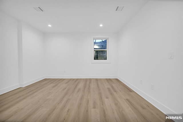 unfurnished room with light hardwood / wood-style floors