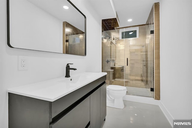 bathroom with tile patterned floors, vanity, toilet, and a shower with door