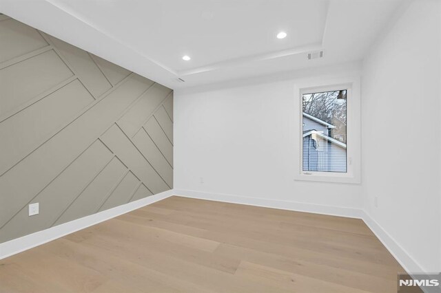 spare room with wood-type flooring